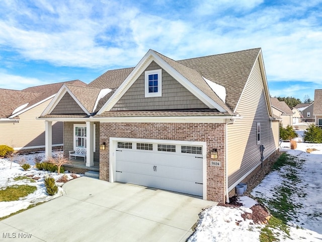 craftsman-style house with central AC unit, a garage, and covered porch