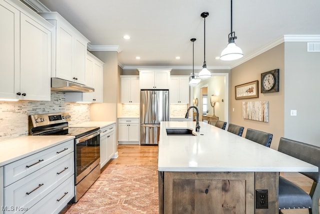 kitchen with sink, a center island with sink, stainless steel appliances, and a kitchen bar