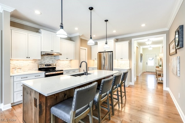 kitchen with sink, hanging light fixtures, a center island with sink, stainless steel appliances, and white cabinets