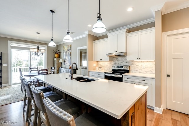 kitchen with white cabinetry, a kitchen island with sink, sink, and stainless steel electric range