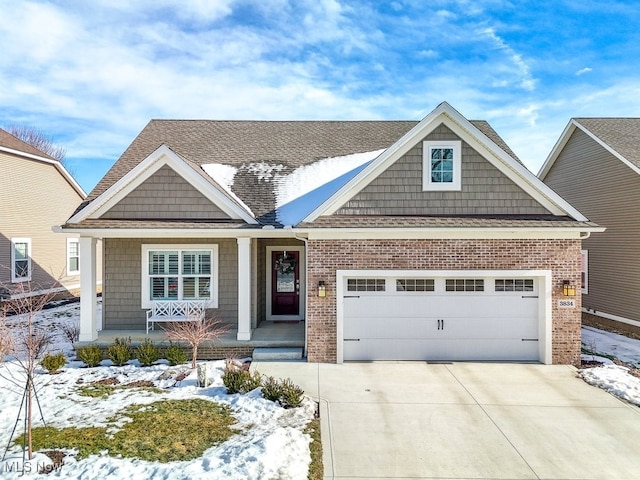 craftsman-style home featuring a garage and covered porch