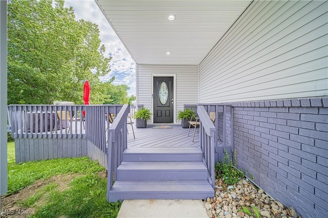 view of exterior entry featuring a deck