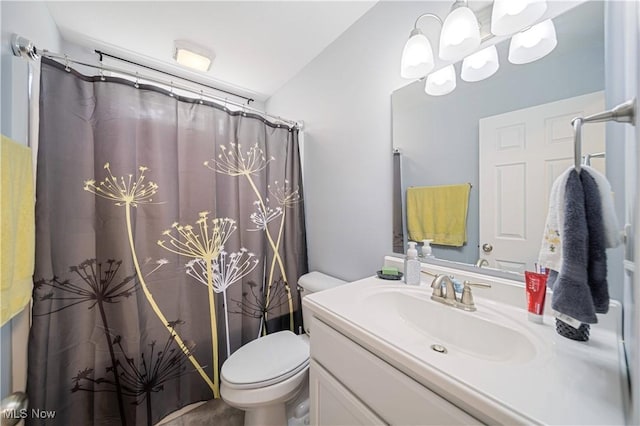 bathroom featuring vanity, a shower with shower curtain, and toilet