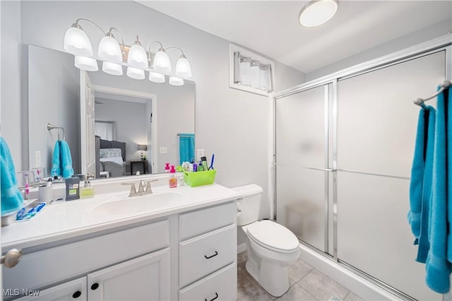 bathroom featuring vanity, toilet, tile patterned flooring, and a shower with door