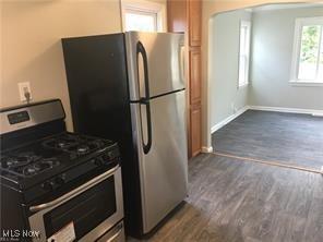 kitchen featuring dark wood-type flooring and appliances with stainless steel finishes