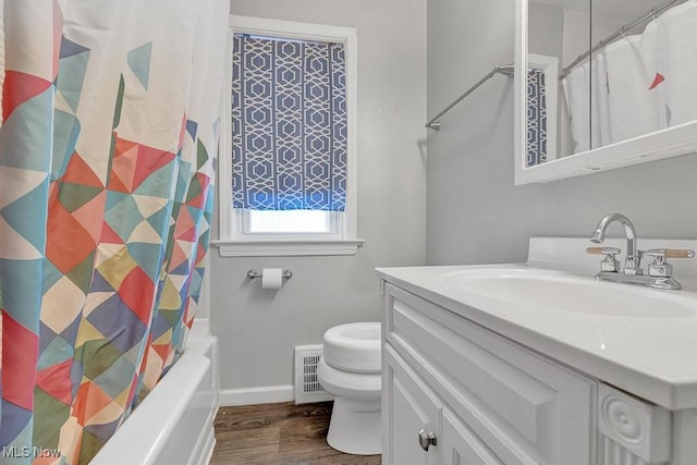 full bathroom featuring wood-type flooring, toilet, vanity, and shower / bath combo