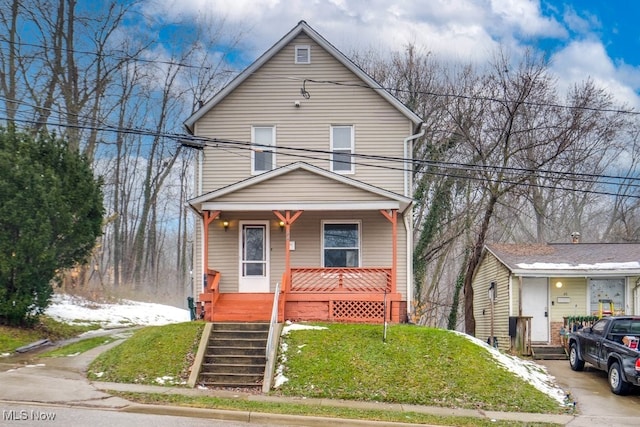 view of property featuring a porch and a front yard