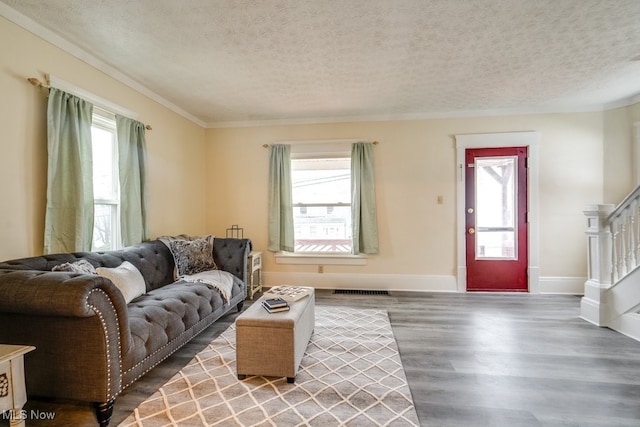 living room featuring wood-type flooring and a textured ceiling