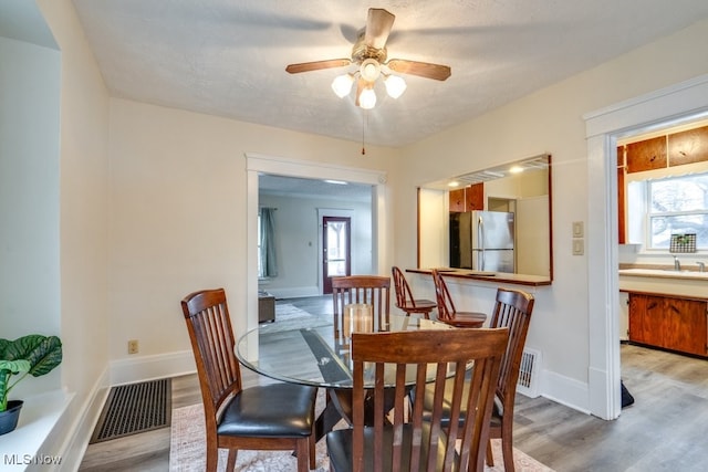 dining area featuring ceiling fan and light hardwood / wood-style flooring