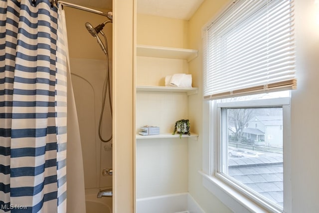 bathroom featuring shower / tub combo with curtain and a healthy amount of sunlight