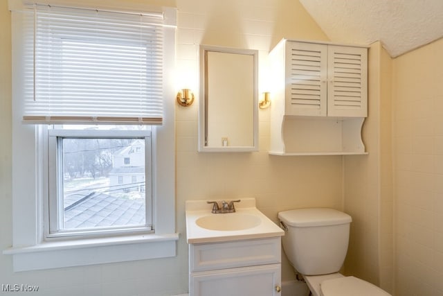 bathroom with vanity, toilet, and a textured ceiling