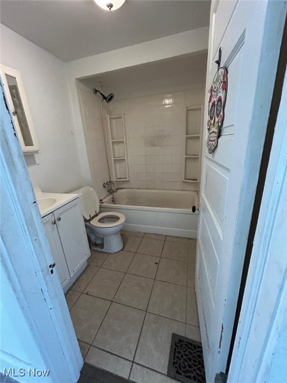 full bathroom with vanity, tiled shower / bath combo, tile patterned floors, and toilet