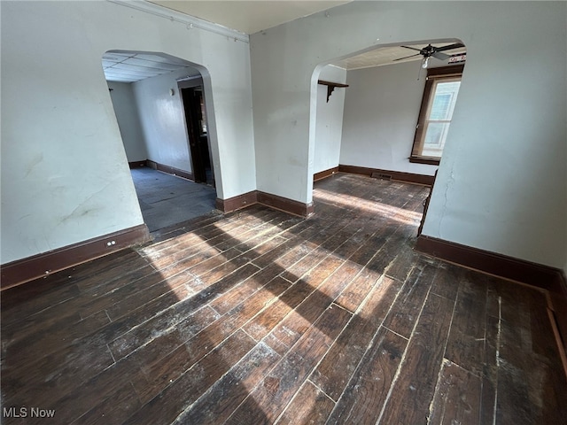 empty room featuring ceiling fan and dark hardwood / wood-style floors