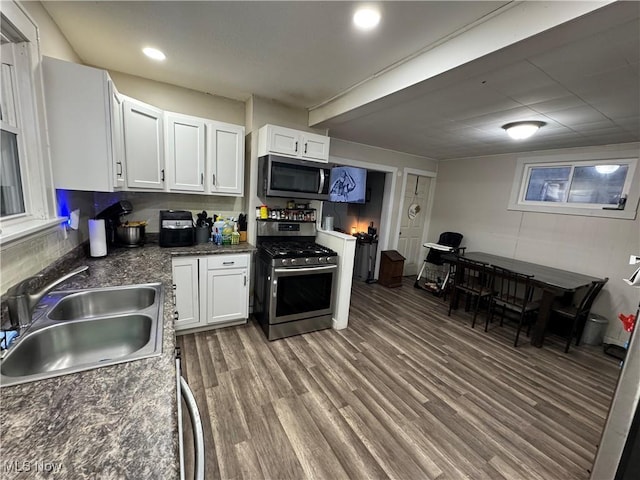 kitchen featuring white cabinetry, stainless steel appliances, sink, and hardwood / wood-style floors