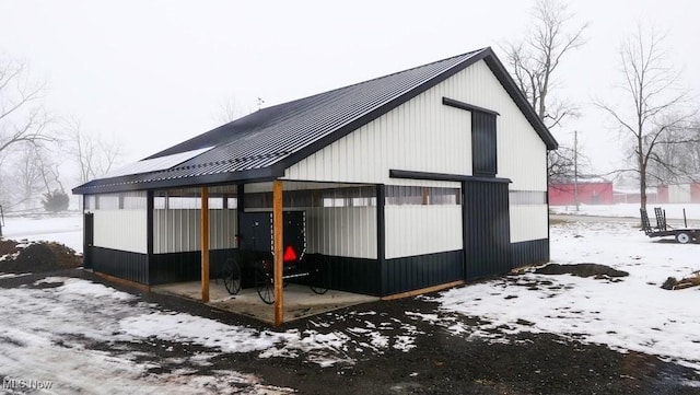 snow covered property with an outdoor structure