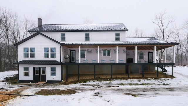 snow covered property with a porch