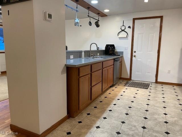 kitchen featuring hanging light fixtures, sink, and dishwasher