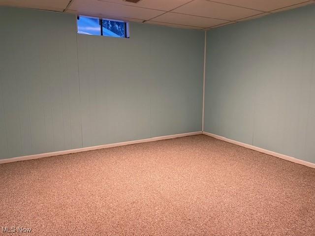 basement with carpet flooring and a drop ceiling