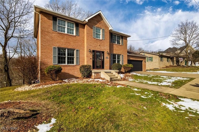 view of front of home with a garage and a front lawn