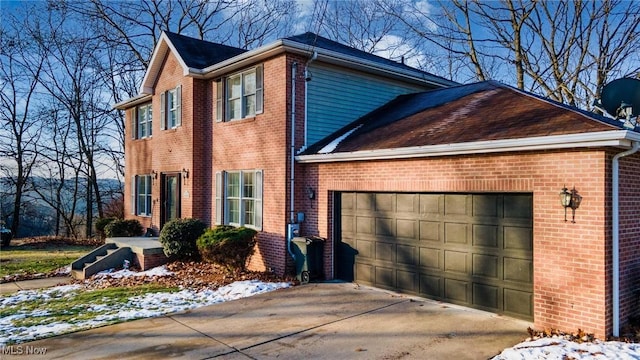 view of snow covered exterior with a garage