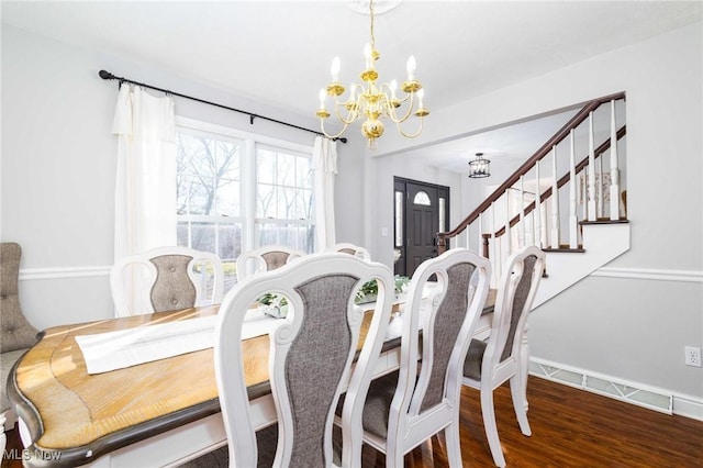 dining area featuring hardwood / wood-style flooring and a chandelier