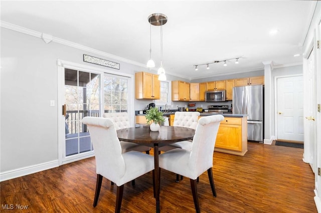 dining space featuring crown molding, dark hardwood / wood-style floors, and sink