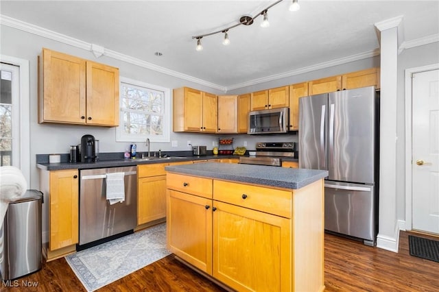 kitchen featuring a kitchen island, dark hardwood / wood-style floors, sink, ornamental molding, and stainless steel appliances