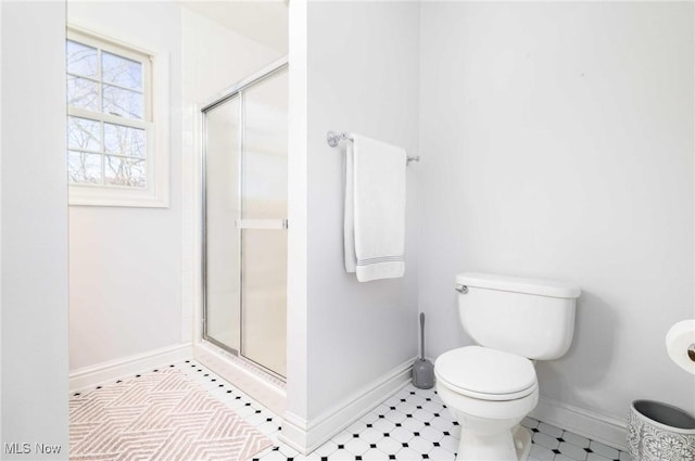 bathroom featuring an enclosed shower and toilet