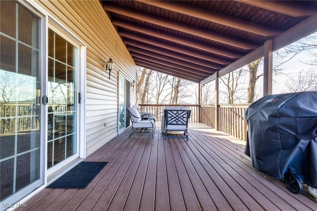 wooden terrace featuring a grill