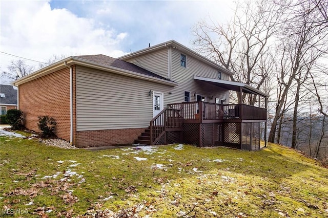 rear view of property featuring a yard and a deck