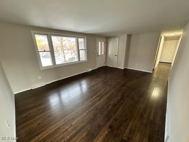 empty room featuring dark wood-type flooring