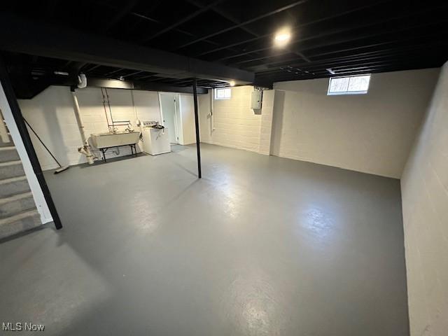 basement featuring separate washer and dryer and sink