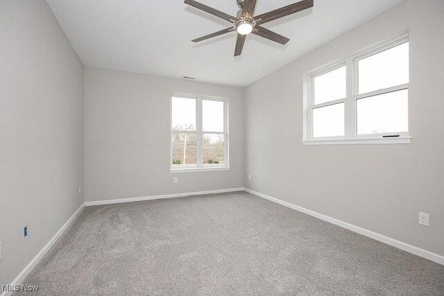 carpeted empty room featuring ceiling fan