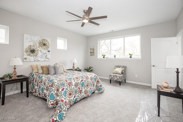 bedroom featuring light colored carpet and ceiling fan