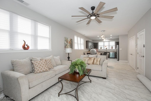 living room with sink and ceiling fan