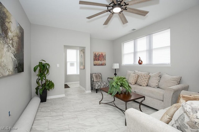 living room featuring a wealth of natural light and ceiling fan