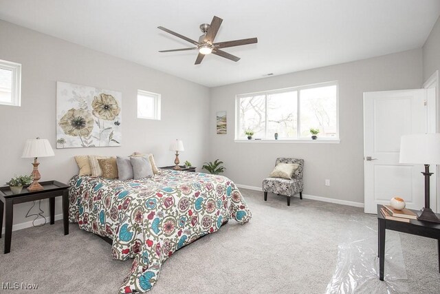 bedroom featuring ceiling fan and light colored carpet