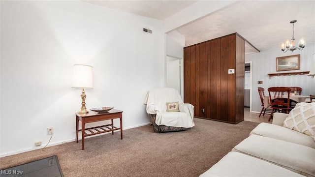 living room with an inviting chandelier and carpet