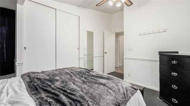 carpeted bedroom featuring ceiling fan and a closet