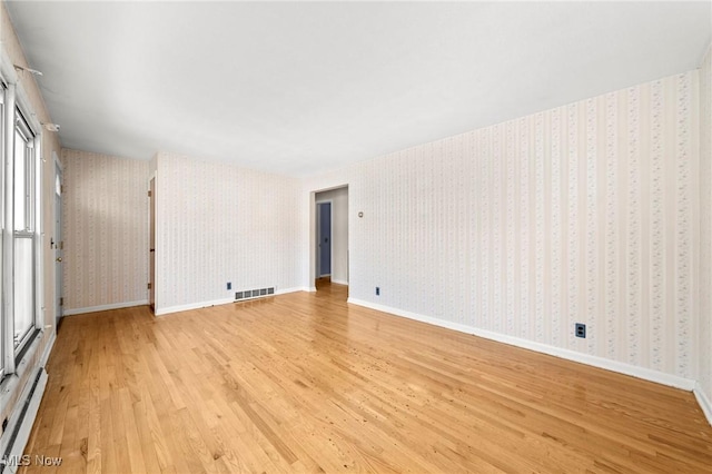 spare room with light hardwood / wood-style flooring and a baseboard heating unit