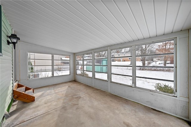 unfurnished sunroom with lofted ceiling and plenty of natural light