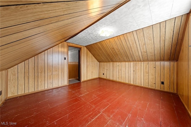 additional living space with wood ceiling, wooden walls, dark hardwood / wood-style flooring, and vaulted ceiling