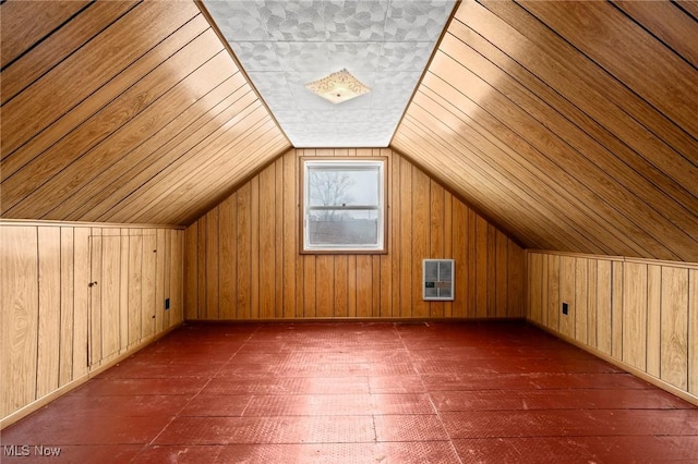 bonus room featuring vaulted ceiling, dark wood-type flooring, heating unit, and wood walls