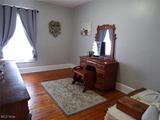 home office featuring wood finished floors and baseboards