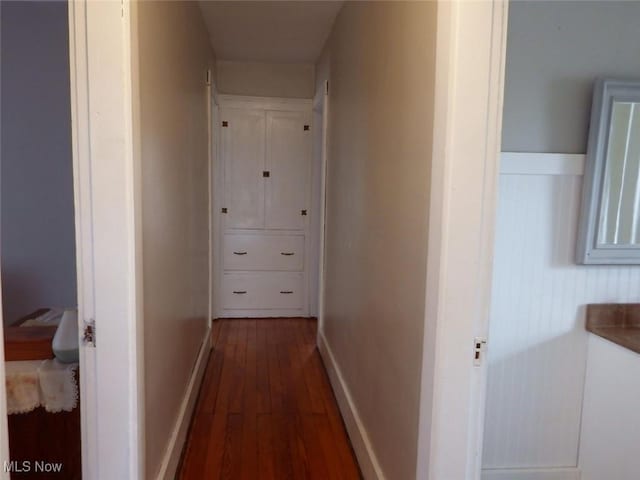 corridor featuring dark hardwood / wood-style flooring