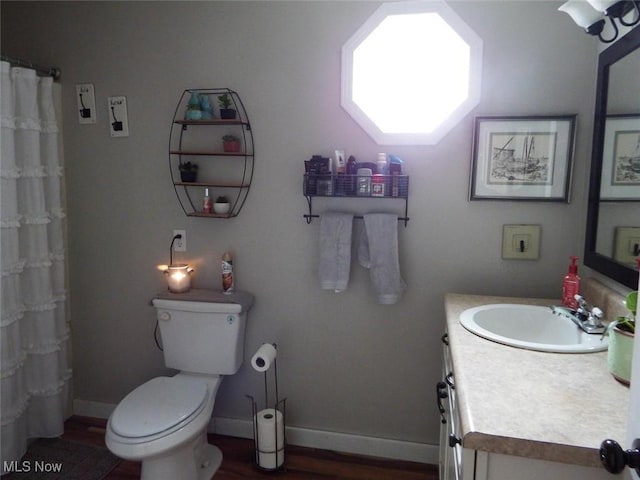 bathroom with vanity, hardwood / wood-style floors, a shower with shower curtain, and toilet