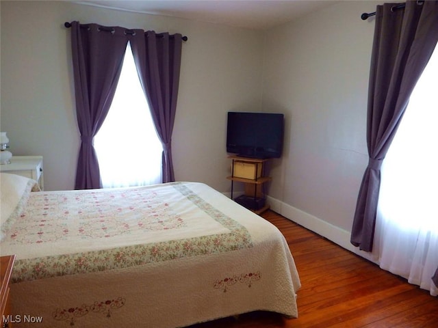 bedroom with wood-type flooring