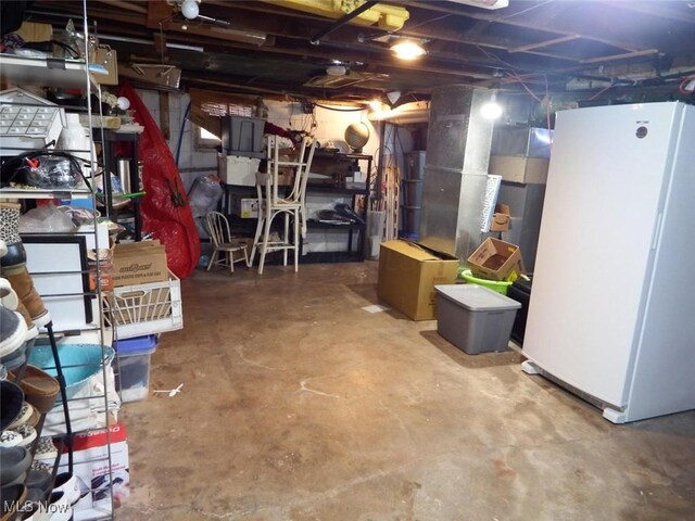 basement with white refrigerator