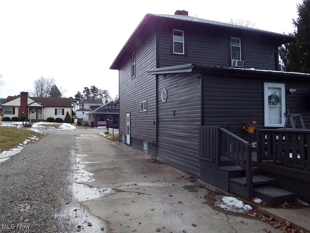 view of property exterior featuring a chimney