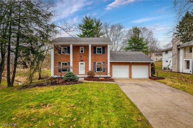 view of front of house featuring a garage and a front lawn